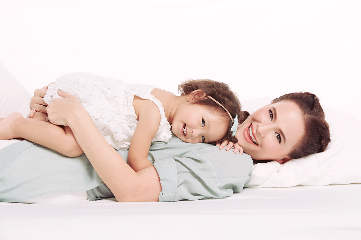 Realistic Asian mother and child smiling in a bright clinic setting
